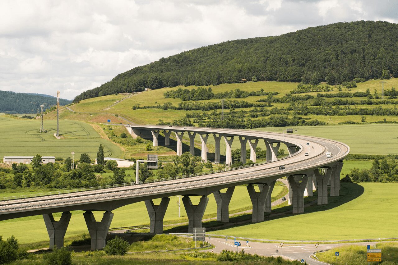 Curved highway over green landscape, representing the digital transformation journey.