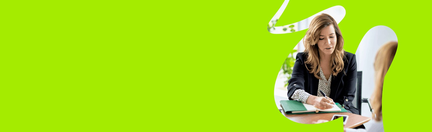 Woman writing notes on Embridge Consulting's ERP consultancy and strategic advisory services in a meeting.