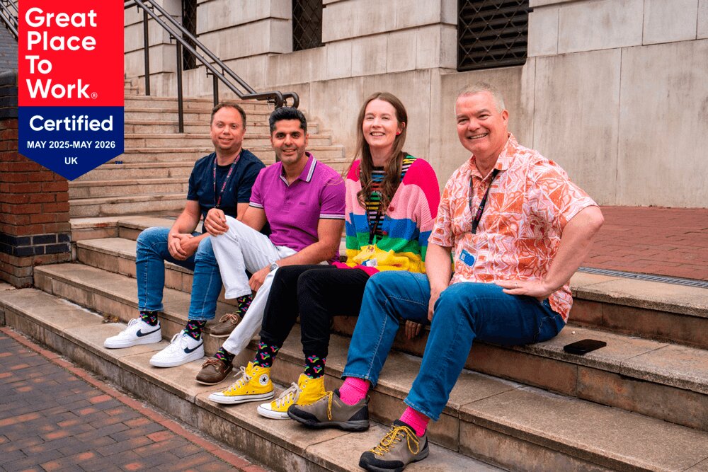 Four Embridge ERP and Digital transformation consultants sitting on stairs.